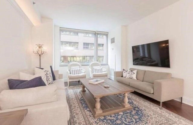 living room with baseboards and wood finished floors