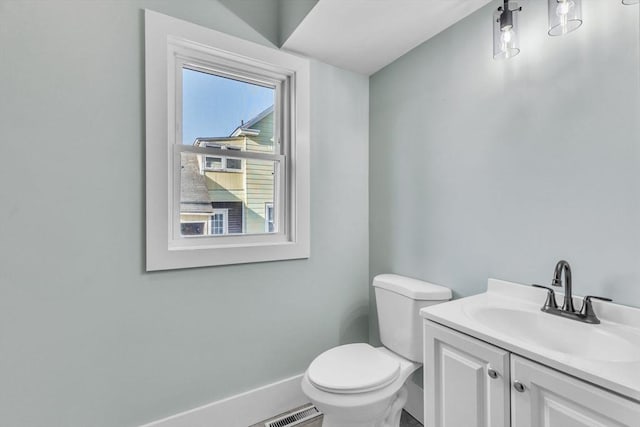 bathroom with toilet and vanity