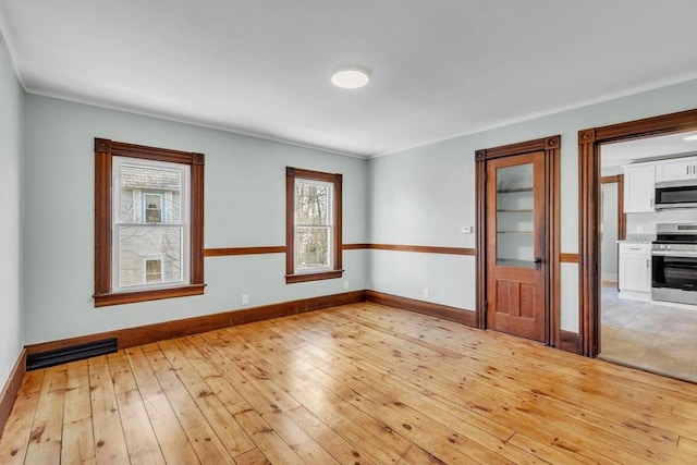 spare room with light hardwood / wood-style floors