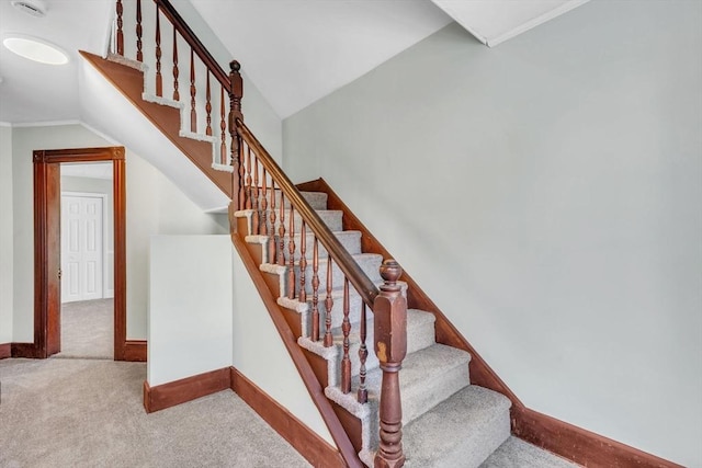 stairs featuring carpet floors and lofted ceiling