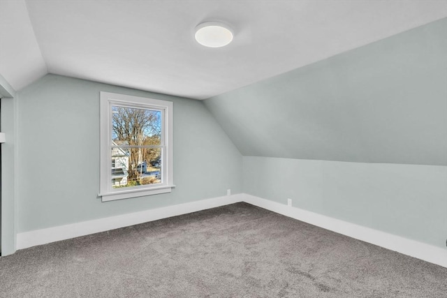 additional living space featuring carpet floors and lofted ceiling