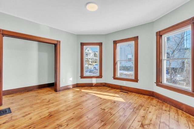 unfurnished room with light wood-type flooring