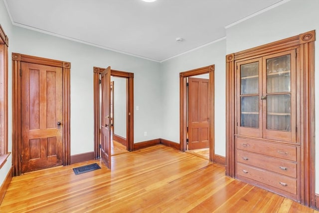 unfurnished bedroom featuring ornamental molding and hardwood / wood-style flooring