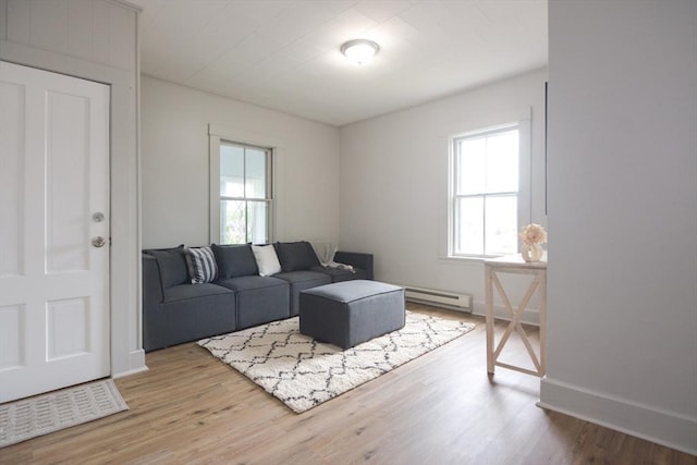 318 Charles St, Fitchburg, MA 01420 - living area featuring a baseboard heating unit, wood finished floors, and baseboards