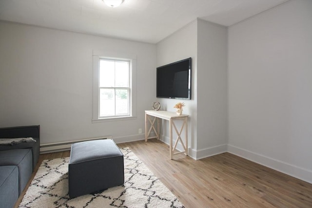 318 Charles St, Fitchburg, MA 01420 - living room with baseboard heating, light wood-style flooring, and baseboards