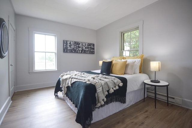 318 Charles St, Fitchburg, MA 01420 - bedroom featuring a baseboard heating unit, wood finished floors, and baseboards