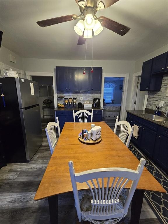 dining room with ceiling fan, dark hardwood / wood-style flooring, and sink