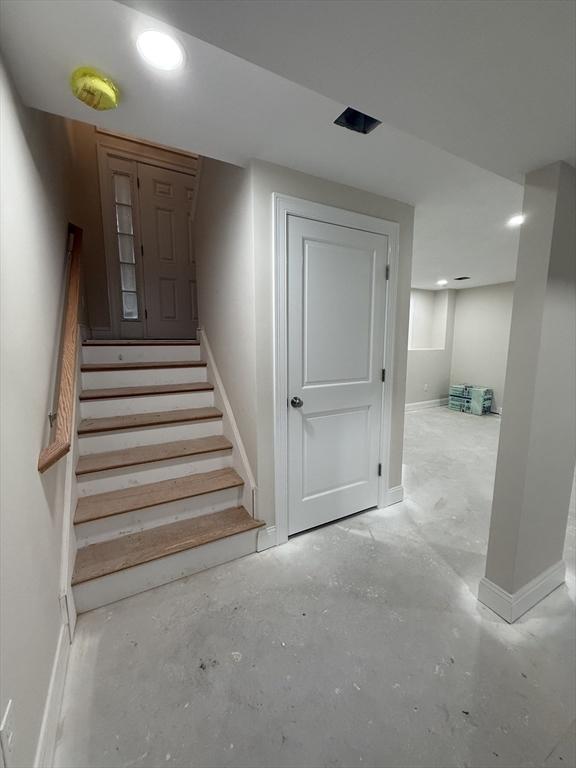 stairway featuring concrete flooring