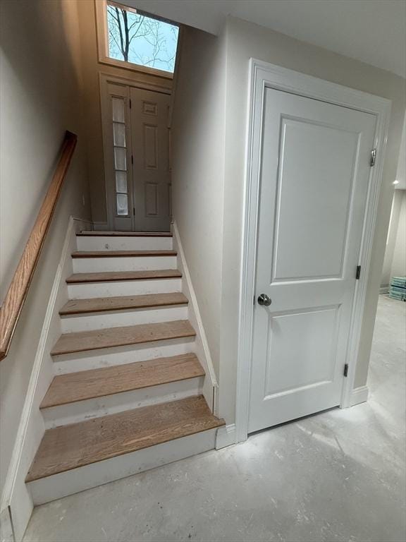 stairway featuring concrete flooring