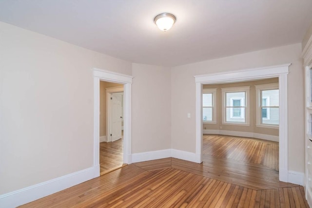 spare room with hardwood / wood-style floors