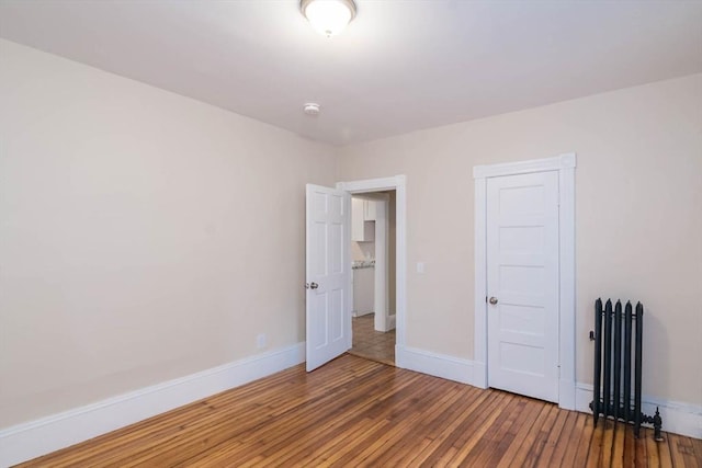 unfurnished bedroom with hardwood / wood-style flooring