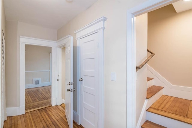 hall with hardwood / wood-style flooring