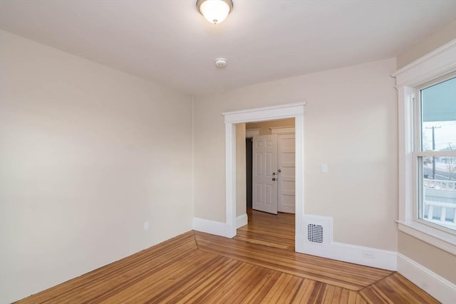 empty room featuring hardwood / wood-style flooring and plenty of natural light