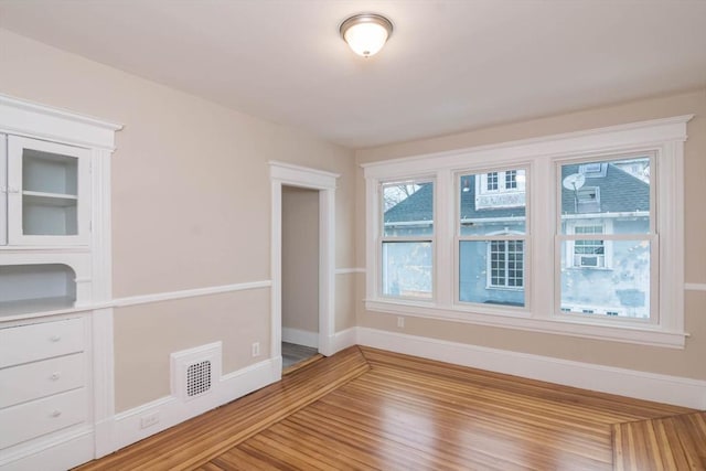 unfurnished room with hardwood / wood-style floors