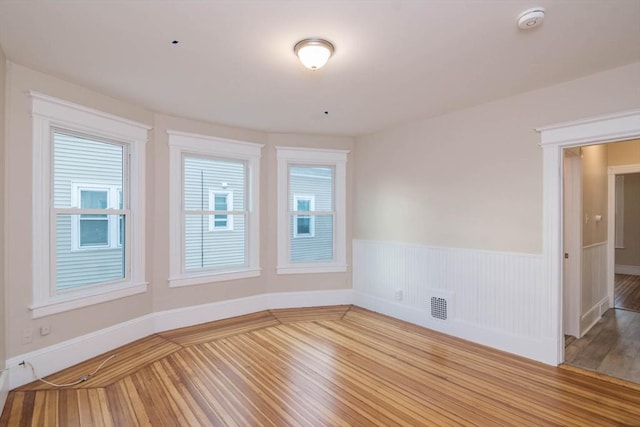 spare room with wood-type flooring