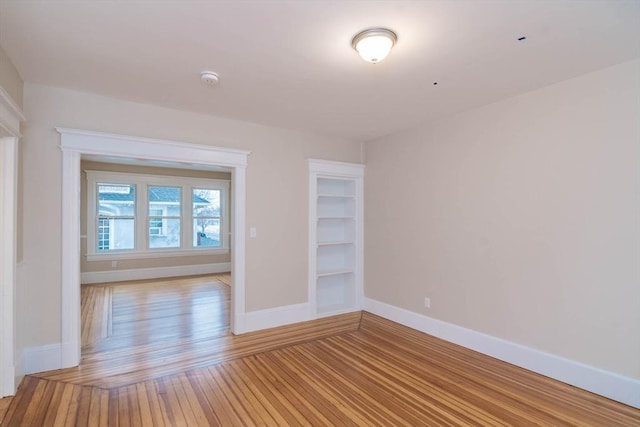 empty room with light hardwood / wood-style flooring