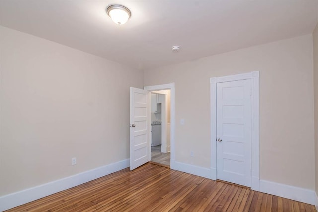 unfurnished bedroom featuring hardwood / wood-style floors and a closet