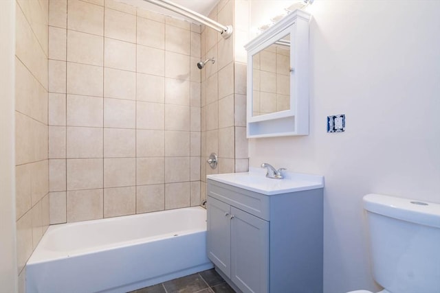 full bathroom with toilet, vanity, and tiled shower / bath