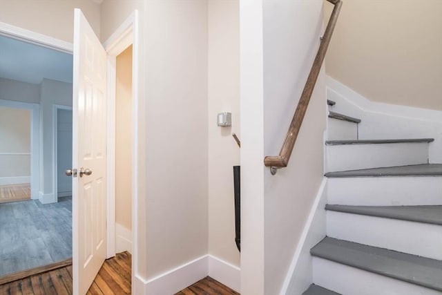 stairs with hardwood / wood-style flooring