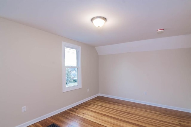 bonus room with light wood-type flooring and lofted ceiling