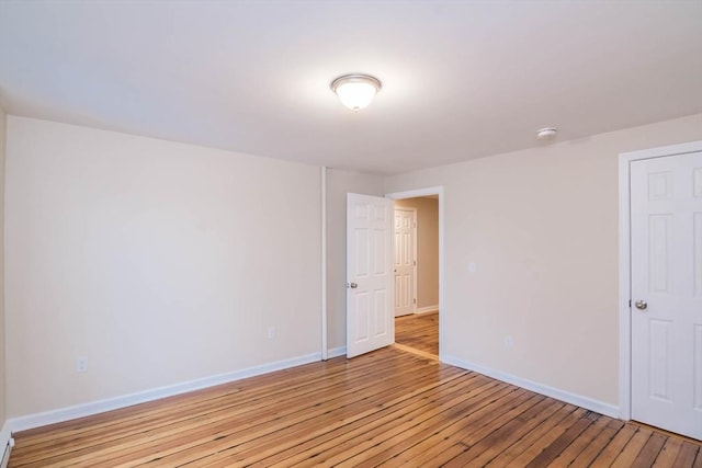 unfurnished room with light wood-type flooring