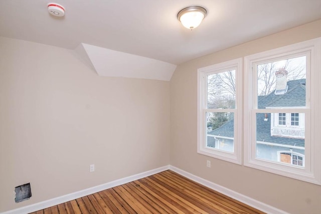 additional living space featuring hardwood / wood-style floors and lofted ceiling