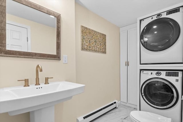 washroom featuring a baseboard heating unit, laundry area, a sink, marble finish floor, and stacked washing maching and dryer