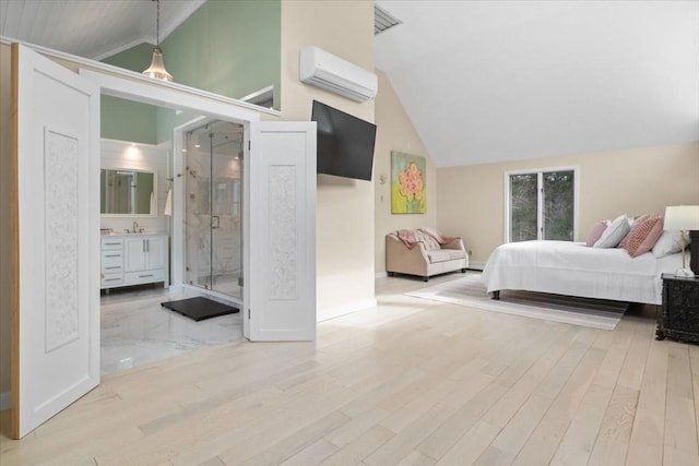 bedroom with lofted ceiling, light wood finished floors, a sink, and a wall mounted air conditioner