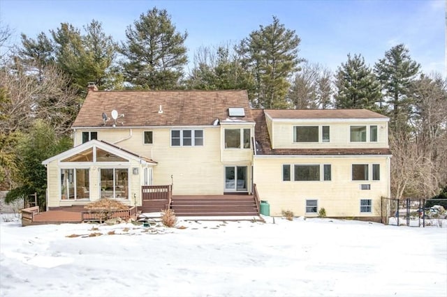 snow covered property featuring a deck