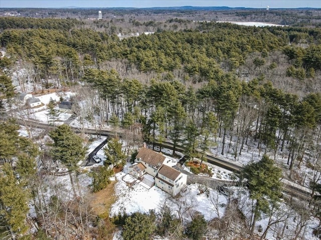 drone / aerial view featuring a wooded view