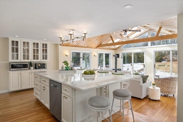 kitchen featuring glass insert cabinets, light countertops, white cabinetry, and a kitchen island