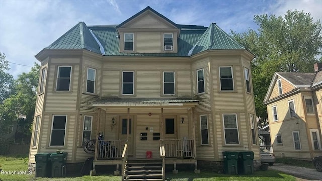 70-72 Chase Ave, North Adams, MA 01247 - view of front of home featuring metal roof, covered porch, and a front yard