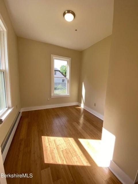 70-72 Chase Ave, North Adams, MA 01247 - empty room featuring baseboard heating, wood finished floors, and baseboards
