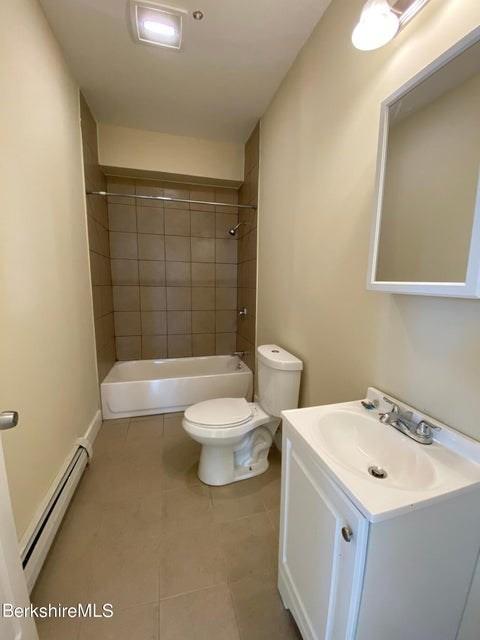 70-72 Chase Ave, North Adams, MA 01247 - full bath with baseboard heating, toilet, vanity, tile patterned floors, and  shower combination