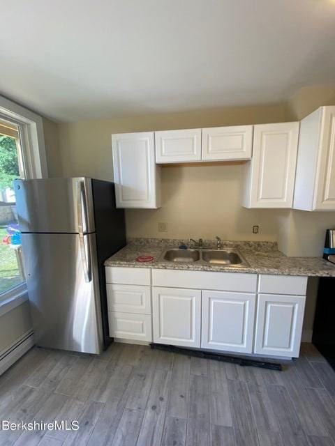 70-72 Chase Ave, North Adams, MA 01247 - kitchen with a sink, freestanding refrigerator, light wood-style floors, and white cabinets