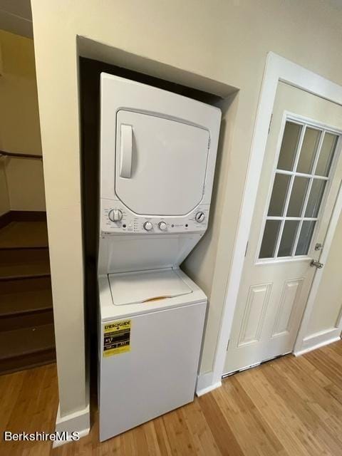 70-72 Chase Ave, North Adams, MA 01247 - laundry room with stacked washer and clothes dryer, light wood-style floors, and baseboards
