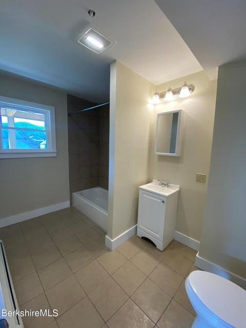 70-72 Chase Ave, North Adams, MA 01247 - bathroom with vanity, tile patterned flooring, toilet, baseboards, and shower / bath combination