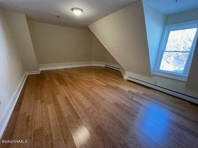 70-72 Chase Ave, North Adams, MA 01247 - additional living space featuring wood finished floors, vaulted ceiling, baseboard heating, and baseboards