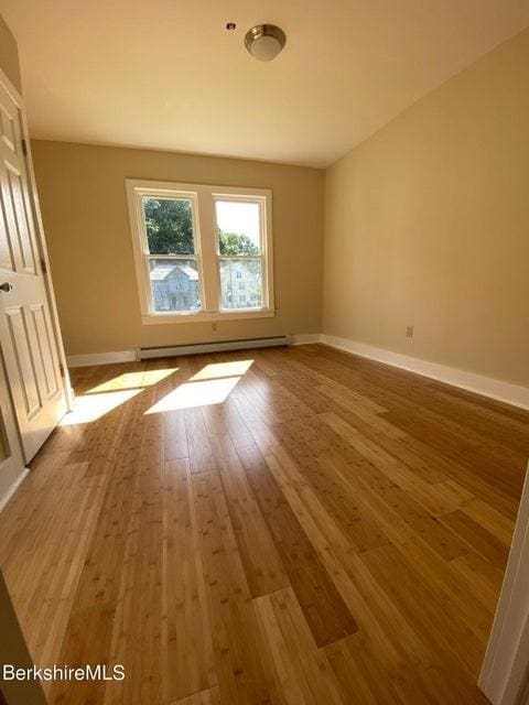 70-72 Chase Ave, North Adams, MA 01247 - spare room featuring a baseboard heating unit, wood finished floors, and baseboards