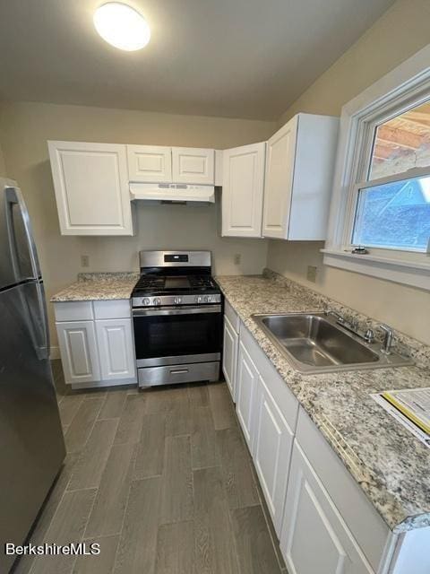70-72 Chase Ave, North Adams, MA 01247 - kitchen featuring stainless steel appliances, under cabinet range hood, a sink, and white cabinetry