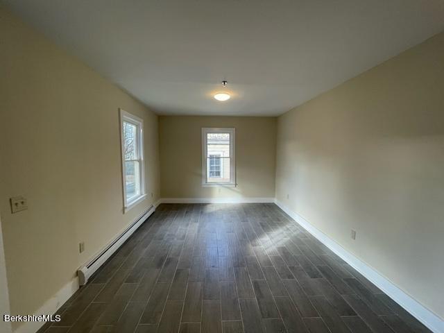 70-72 Chase Ave, North Adams, MA 01247 - empty room with a baseboard radiator, dark wood-type flooring, and baseboards