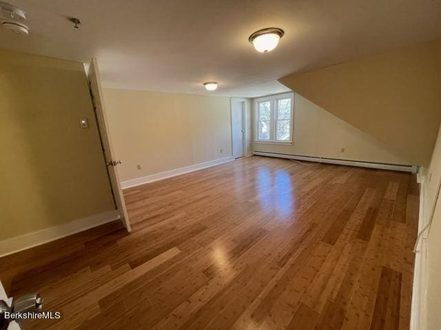 70-72 Chase Ave, North Adams, MA 01247 - additional living space featuring a baseboard heating unit, wood finished floors, and baseboards