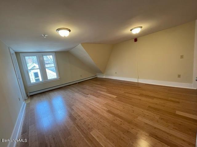 70-72 Chase Ave, North Adams, MA 01247 - bonus room featuring wood finished floors, a baseboard heating unit, vaulted ceiling, and baseboards