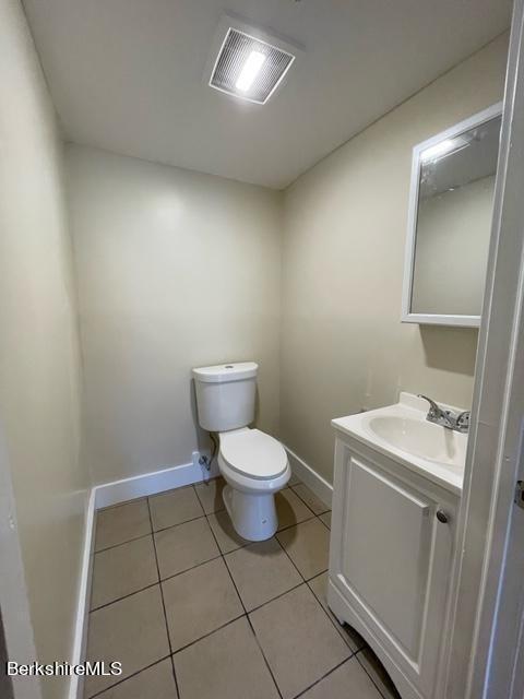 70-72 Chase Ave, North Adams, MA 01247 - bathroom with toilet, vanity, baseboards, and tile patterned floors