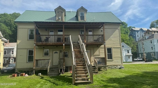 70-72 Chase Ave, North Adams, MA 01247 - back of property with a lawn, metal roof, and stairs