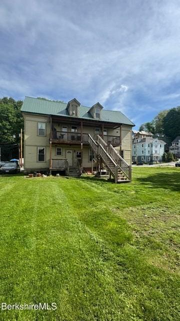 70-72 Chase Ave, North Adams, MA 01247 - rear view of house with stairs, a lawn, a deck, and metal roof