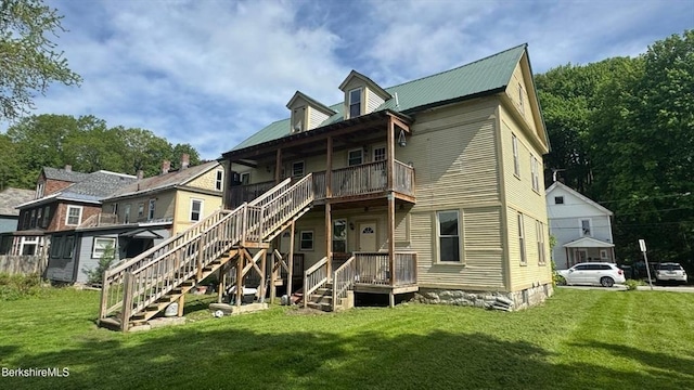 70-72 Chase Ave, North Adams, MA 01247 - rear view of house with stairway, a lawn, and metal roof