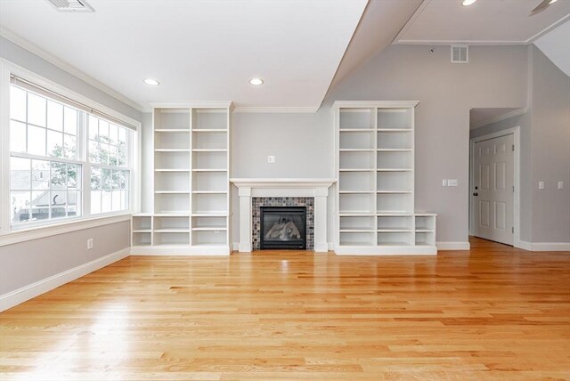 hallway with light hardwood / wood-style flooring and crown molding