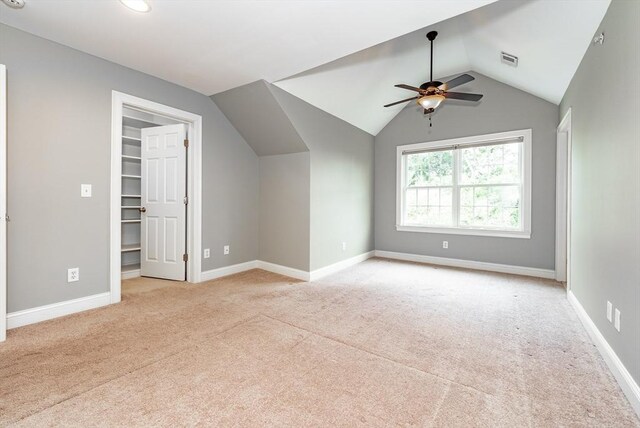 bonus room with light carpet and vaulted ceiling