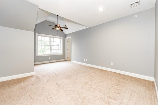 additional living space with ceiling fan, lofted ceiling, and carpet flooring